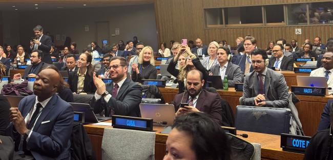 Delegates applaud at the conclusion of PrepCom III