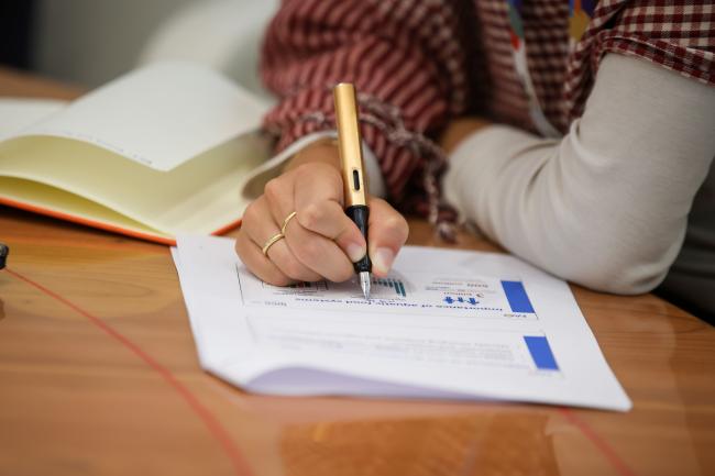 A participant takes notes.