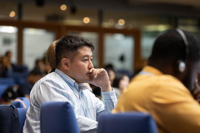 Delegates listen to the interventions