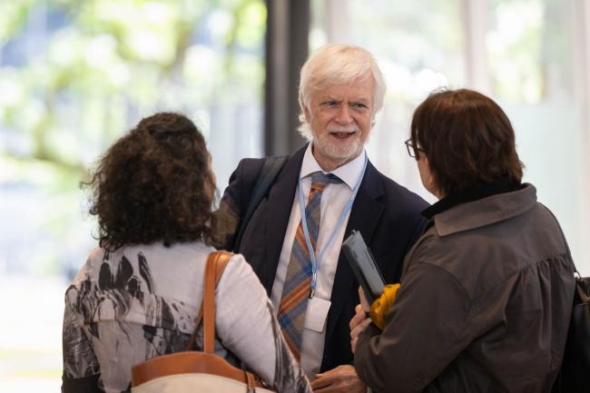 Jim Skea, Chair, Intergovernmental Panel on Climate Change (IPCC), speaks with colleagues
