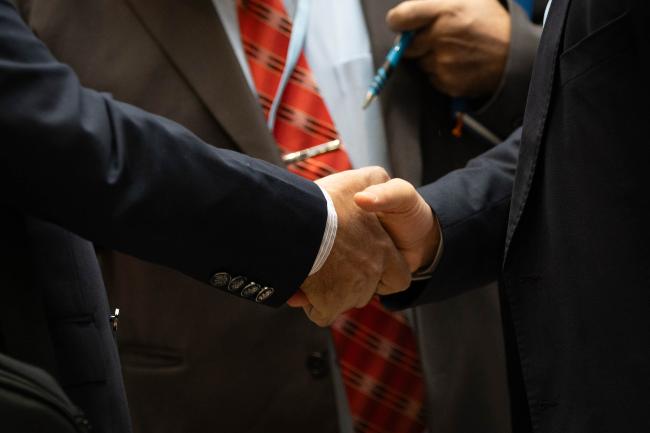 Delegates shake hands
