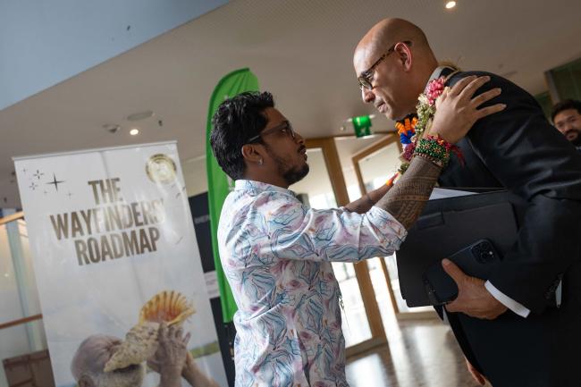 Shiva Gounden, Head, Pacific Greenpeace, gives UNFCCC Executive Secretary Simon Stiell a tour of 'The Wanderers Roadmap' exhibition