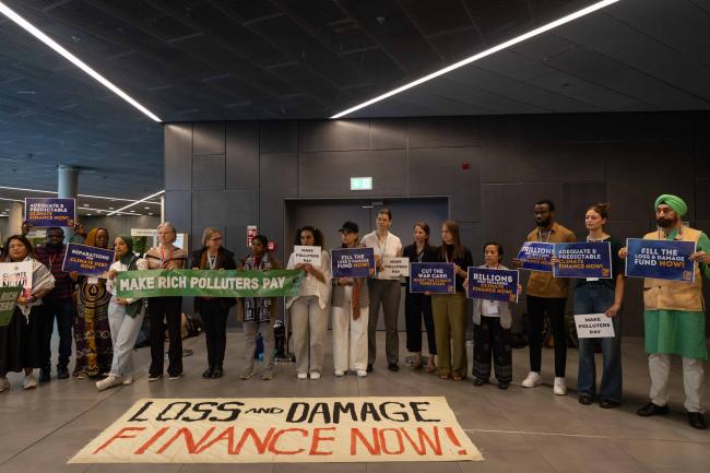 Members of civil society demonstrate in the corridors, calling for more finance to address loss and damage and to 'make rich polluters pay'