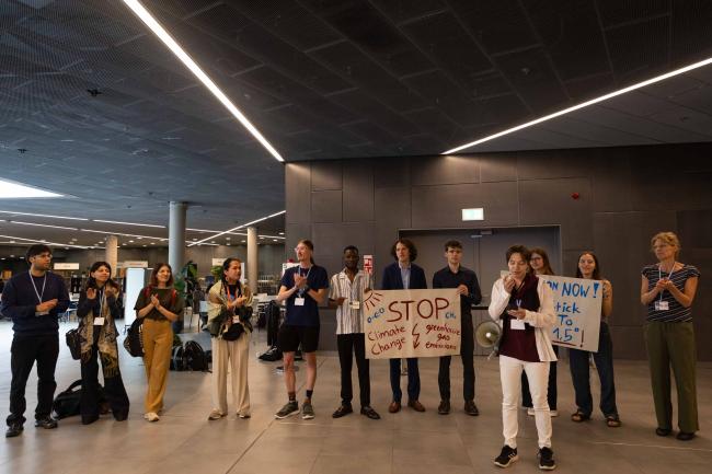 Members of civil society demonstrate, calling for ambitious mitigation action to keep 1.5°C alive