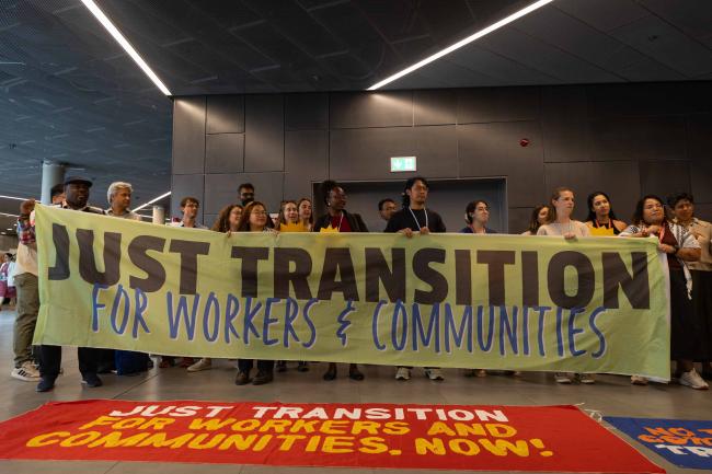Members of civil society demonstrate in the corridors, calling for a just transition for workers and communities