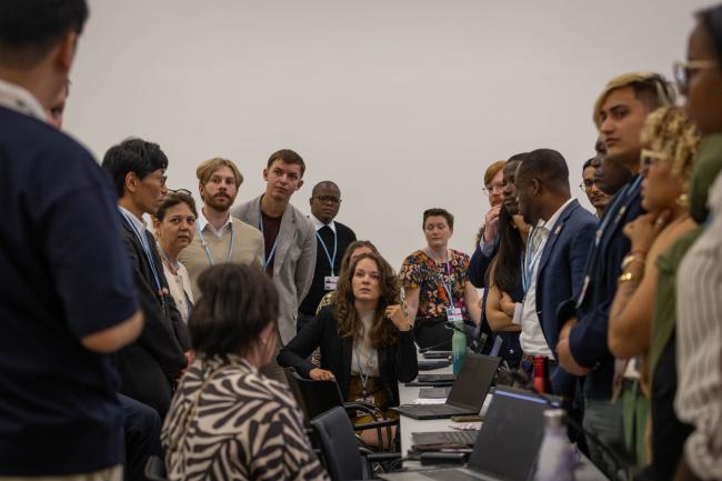 Delegates huddle during the informal consultations on matters relating to Action for Climate Empowerment (ACE)