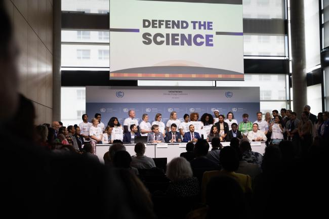 As delegates struggle to reach agreement on a range of issues, a press conference is held to remind delegates to 'defend the science'