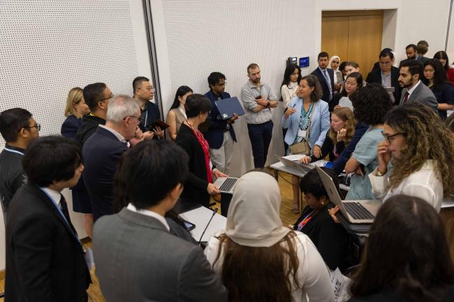 Delegates huddle during the informal consultation on response measures