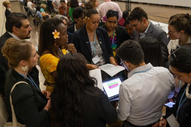 Delegates from the Alliance of Small Island States (AOSIS) and Least Developed Countries (LDCs) huddle informally