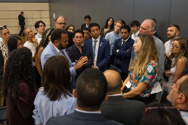 Delegates huddle during the informal consultations on the mitigation work programme