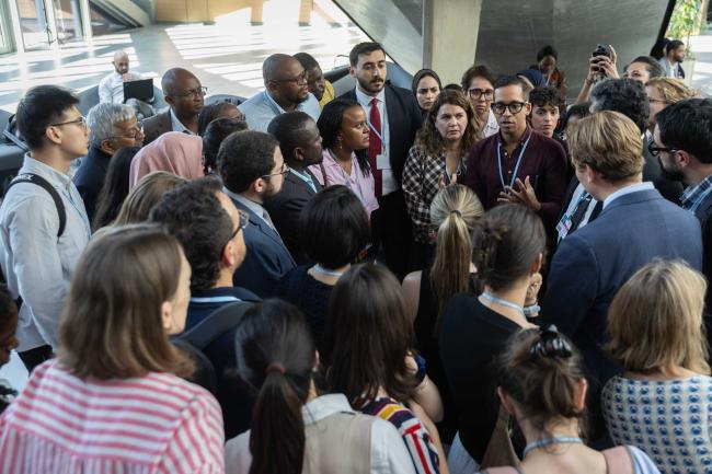 As closing plenary continues, delegates huddle informally in the corridors to find a way forward on outstanding issues