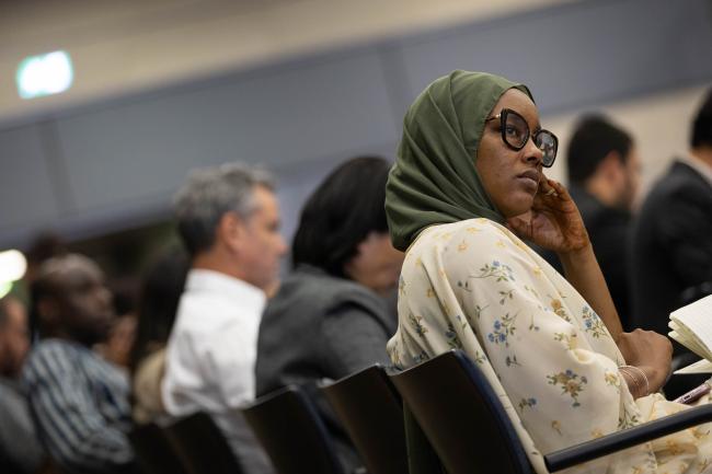 Delegates listen to the discussion