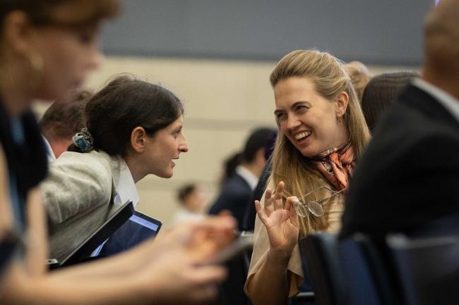 Delegates consult during the session