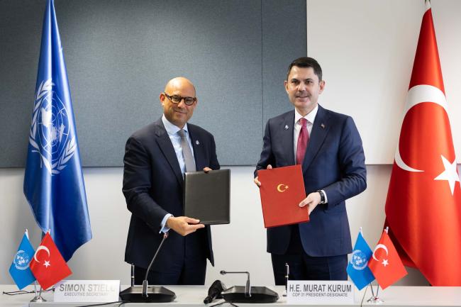UNFCCC Executive Secretary Simon Stiell and COP 31 President-Designate Murat Kurum, Türkiye, sign the Host Country Agreement for COP 31