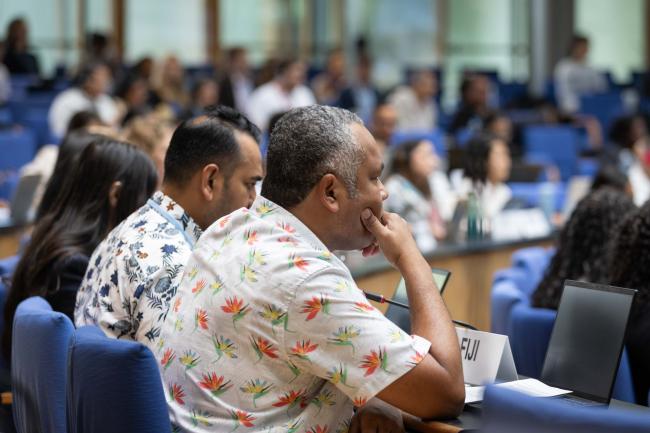 Delegates listen to the discussion