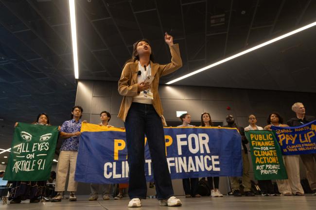 Members of civil society demonstrate in the corridors, calling for countries to 'pay up for climate finance'