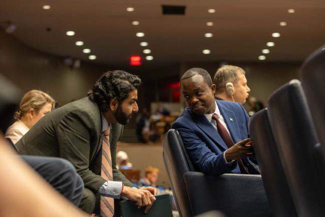 Delegates consult between sessions