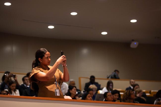 Delegates document the proceedings from the gallery