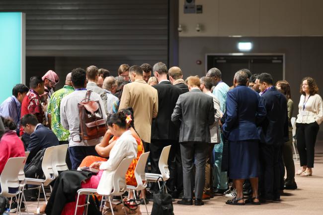 Delegates formed a huddle during informal consultations on long-term climate finance